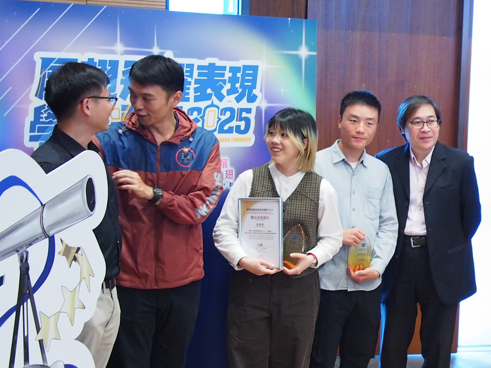 Awardees with guests, family and friends, employers and service providers taking photos together