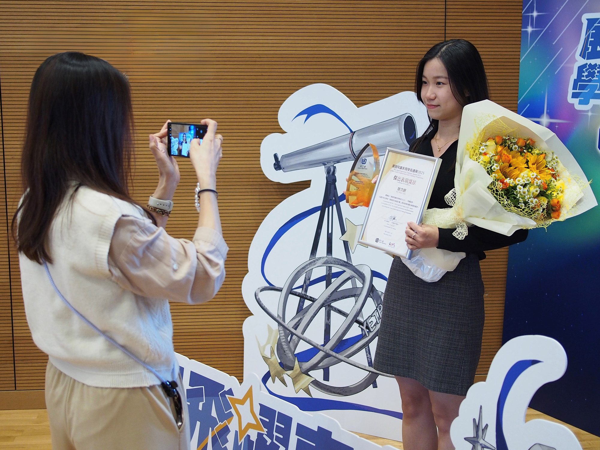 Awardees with guests, family and friends, employers and service providers taking photos together